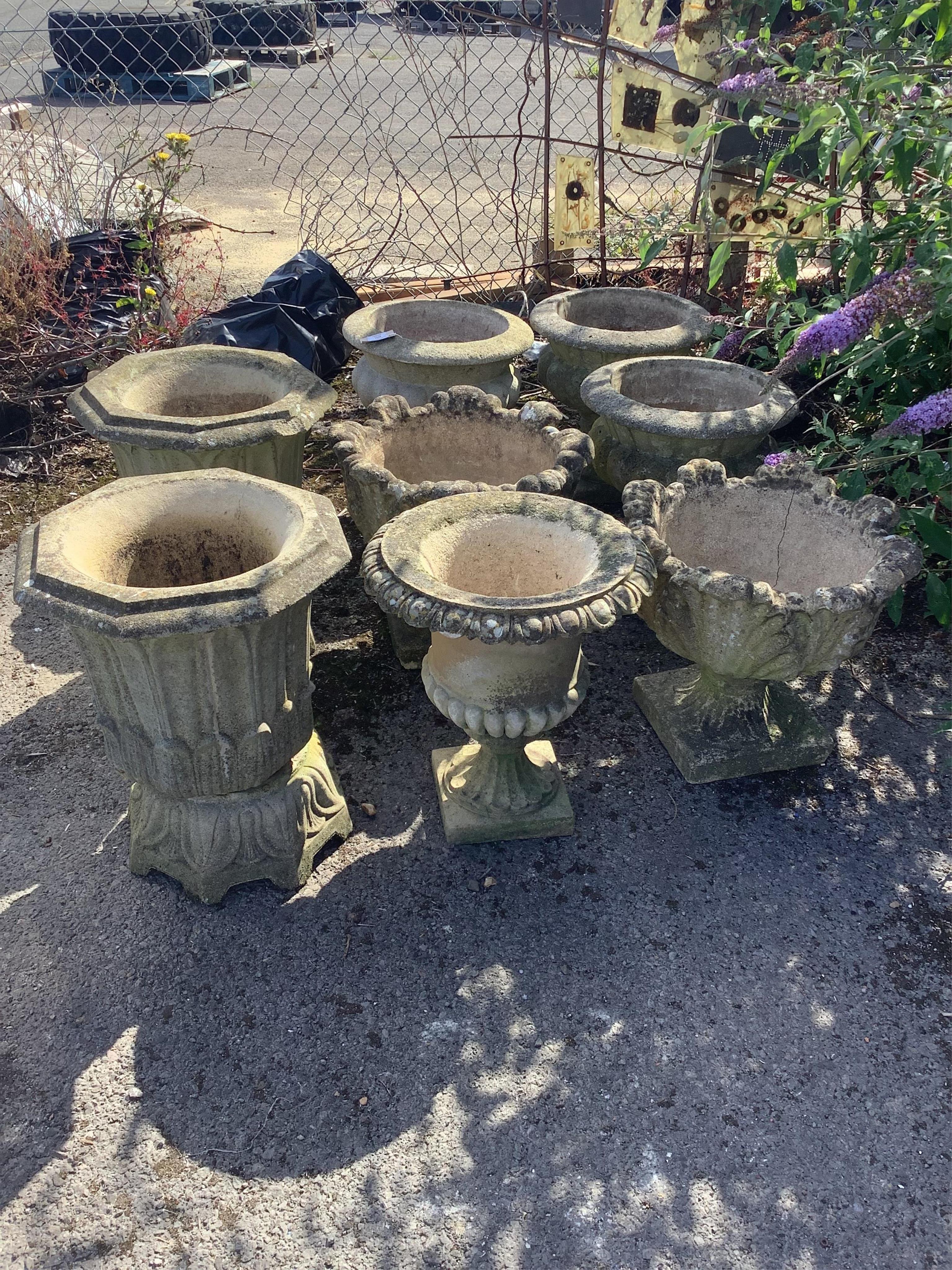 Four (three plus one) circular reconstituted stone garden planters, larger diameter 40cm, height 41cm, a pair of Haddonstone 'lotus' octagonal stone planters, width 40cm, height 50cm and a two pairs of garden urns, large